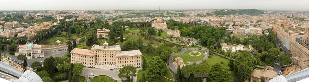 Panoramic view of Vatican City from St. Peter's Basilica, showcasing the gardens and papal palace.