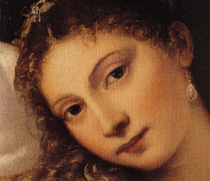 Close-up detail of the face of "The Venus of Urbino," a painting by Titian, showcasing the subject's serene expression and soft features.