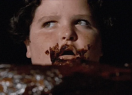 GIF of Bruce eating cake in the movie Mathilda 1996.