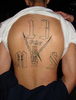 The visible tattoos of MS-13 act as a lifelong marker, making it nearly impossible to leave. A physical version of a non-compete clause.